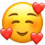 SMILING FACE WITH SMILING EYES AND THREE HEARTS